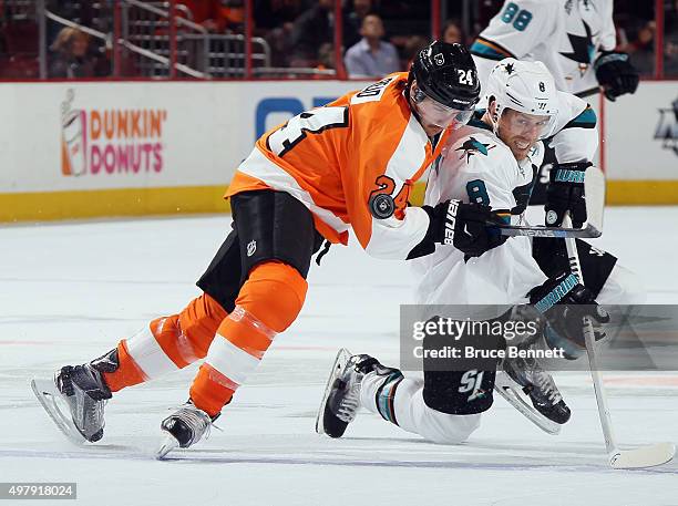Matt Read of the Philadelphia Flyers checks Joe Pavelski of the San Jose Sharks during the first period at the Wells Fargo Center on November 19,...