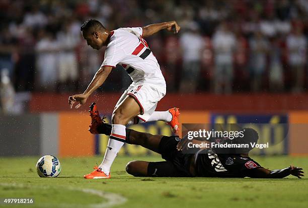 Luis Fabiano of Sao Paulo fights for the ball with Jemerson of Atletico during the match between Sao Paulo and Atletico MG for the Brazilian Series A...