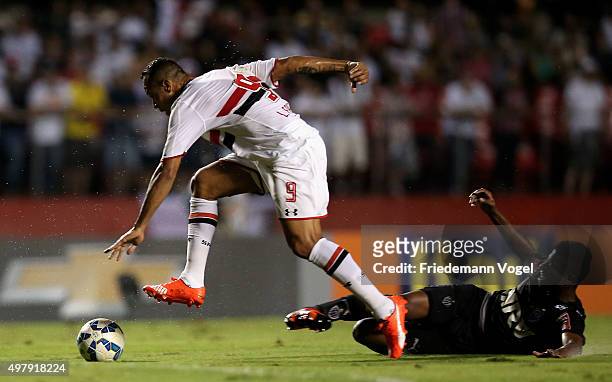 Luis Fabiano of Sao Paulo fights for the ball with Jemerson of Atletico during the match between Sao Paulo and Atletico MG for the Brazilian Series A...