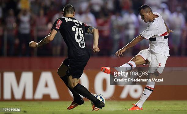 Luis Fabiano of Sao Paulo fights for the ball with Tiago of Atletico during the match between Sao Paulo and Atletico MG for the Brazilian Series A...