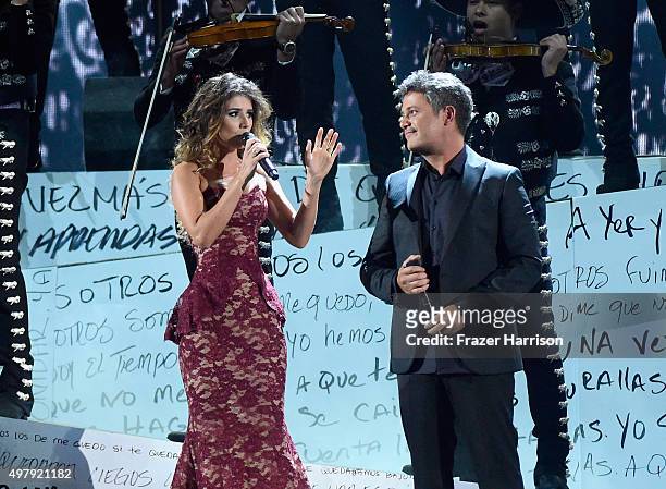 Recording artists Paula Fernandes and Alejandro Sanz peform with Mariachi Sol de Mexico onstage during the 16th Latin GRAMMY Awards at the MGM Grand...