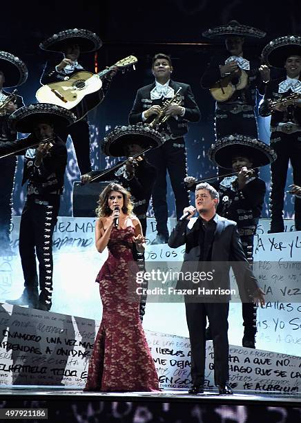 Recording artists Paula Fernandes and Alejandro Sanz peform with Mariachi Sol de Mexico onstage during the 16th Latin GRAMMY Awards at the MGM Grand...