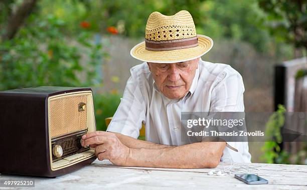 senior man listening radio - tuning stock pictures, royalty-free photos & images