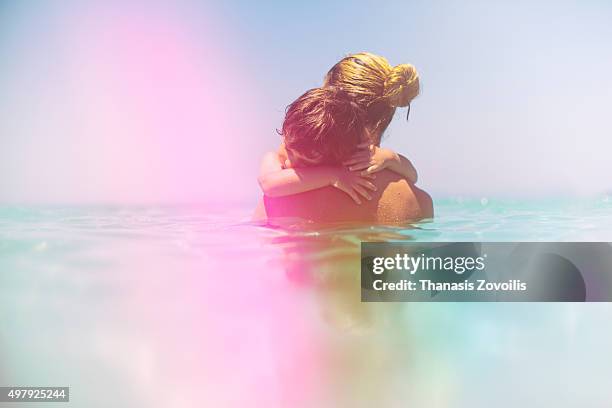 mother with her son - baby swim imagens e fotografias de stock