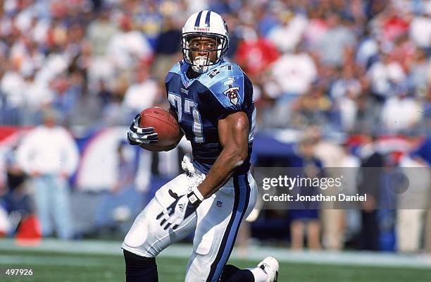 Eddie George of the Nashville Titans carries the ball during a game against the St. Louis Rams at the Adelphia Coliseum in Nashville, Tennessee. The...