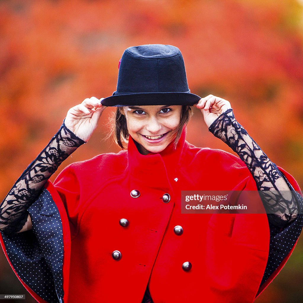 Teen girl in the hat and red coat dance