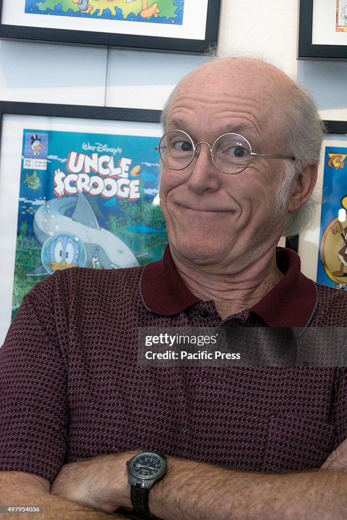 Comic artist Don Rosa smiling in front of the exhibition.