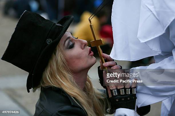 Madonna lookalike kisses a gold cross.