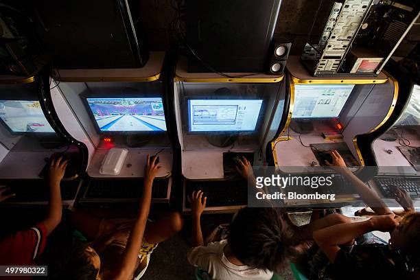 Children play computer games at an internet cafe in the Tondo district of Manila, the Philippines, on Thursday, Nov. 19, 2015. Philippine gross...