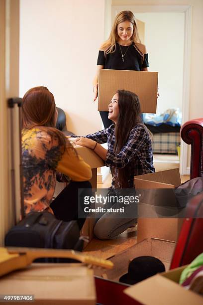 female students moving into new flat - teen packing suitcase stock pictures, royalty-free photos & images