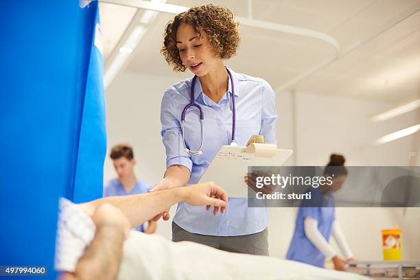 female doctor on the hospital ward - junior doctor stock pictures, royalty-free photos & images