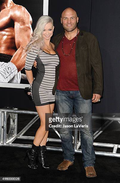 Mindy Robinson and Randy Couture attend the premiere of "Creed" at Regency Village Theatre on November 19, 2015 in Westwood, California.