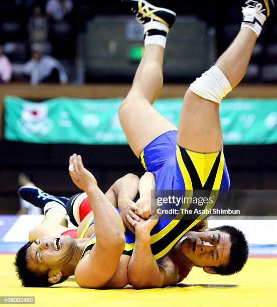 Shingo Matsumoto scores points against Mitsuhiro Ota in the Greco-Roman -84kg final during day one of the All Japan Wrestling Championships at Yoyogi...