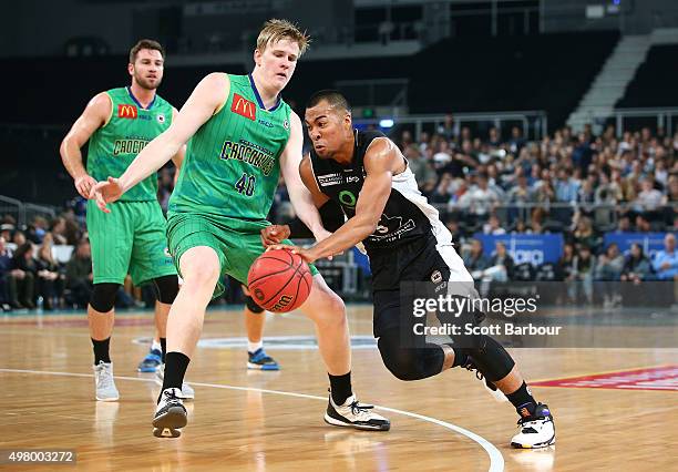 Stephen Holt of Melbourne United and Brent Wallace of the Townsville Crocodiles compete for the ball during the round seven NBL match between...