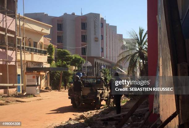 Malian troops take position outside the Radisson Blu hotel in Bamako on November 20, 2015. Gunmen went on a shooting rampage at the luxury Radisson...