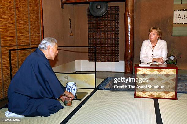 German Chancellor Angela Merkel is offered a bowl of Japanese tea at the Urasenke School Konnichian on August 31, 2007 in Kyoto, Japan.