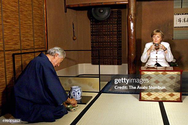 German Chancellor Angela Merkel is offered a bowl of Japanese tea at the Urasenke School Konnichian on August 31, 2007 in Kyoto, Japan.