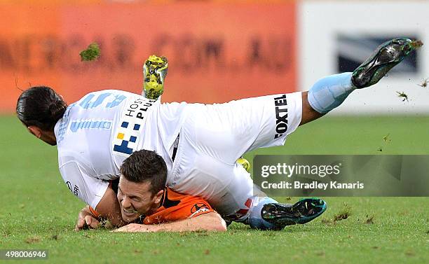 David Williams of Melbourne City lands on top of Matt McKay of the Roar after fouling him in the tackle during the round seven A-League match between...