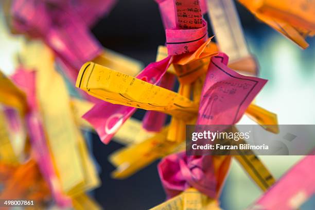 bad fortune tied to sticks at tenmangu shrine. - tenmangu shrine stock pictures, royalty-free photos & images