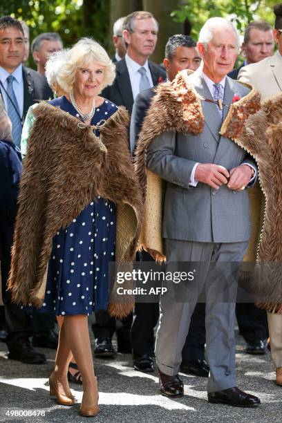 Britain's Prince Charles and Camilla, Duchess of Cornwall receive a traditional welcome as they arrive dressed in Korowai during a visit to...