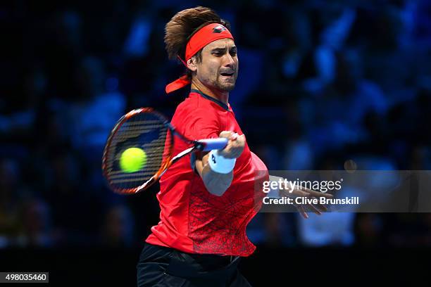 David Ferrer of Spain hits a forehand during the men's singles match against Rafael Nadal of Spain on day six of the Barclays ATP World Tour Finals...