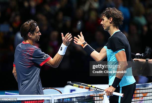 The victorious Rafael Nadal of Spain shakes hands with David Ferrer of Spain following his victory during their men's singles match on day six of the...