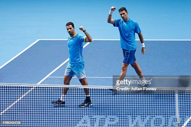 Jean-Julien Rojer of Netherlands and Horia Tecau of Romania celebrate following their victory during the men's doubles match against Pierre Hugues...