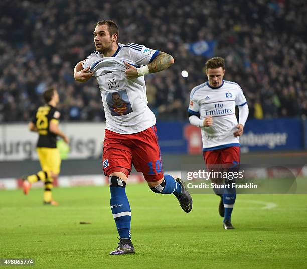 Pierre - Michel Lasogga of Hamburg celebrates scoring the first goal as he wears a tee shirt with a picture of him as superman during the Bundesliga...