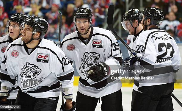 Derek Joslin, David Steckel and Sasa Martinovic of the Thomas Sabo Ice Tigers Nuernberg celebrate after scoring the 1:1 during the game between the...