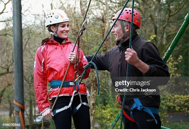 Catherine, Duchess of Cambridge reacts as she prepares to abseil during a visit to the Towers Residential Outdoor Education Centre on November 20,...