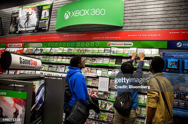 Customers browse Microsoft Corp. Xbox video games displayed for sale at a GameStop Corp. Store in New York, U.S., on Wednesday, Nov. 18, 2015....