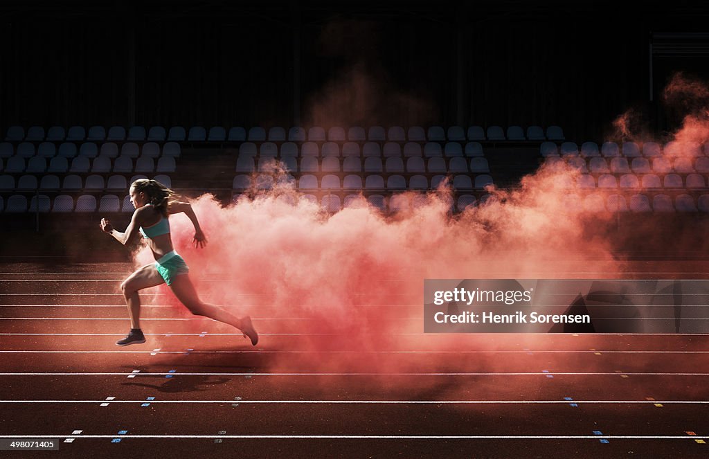 Athlete running in red smoke