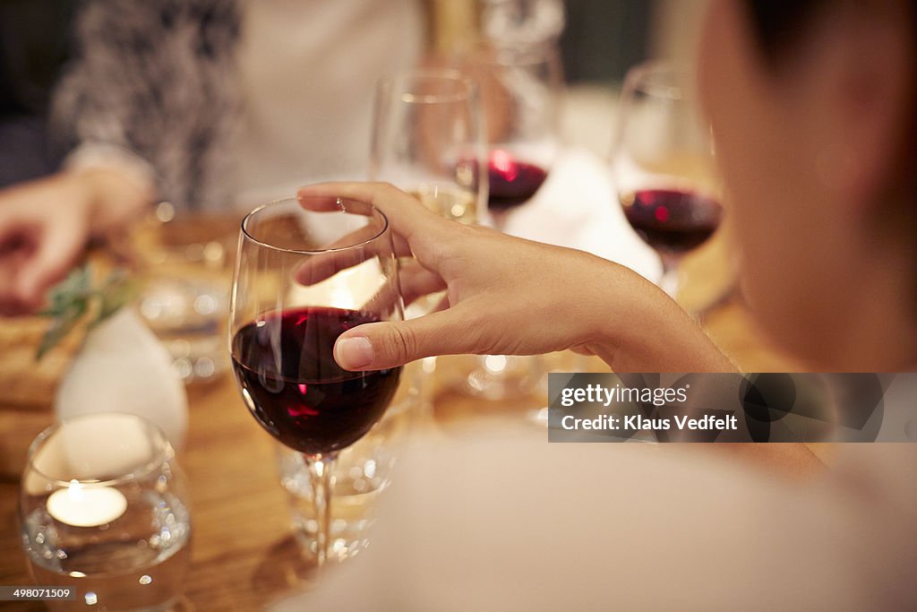 Close-up of female holding glass with redwine