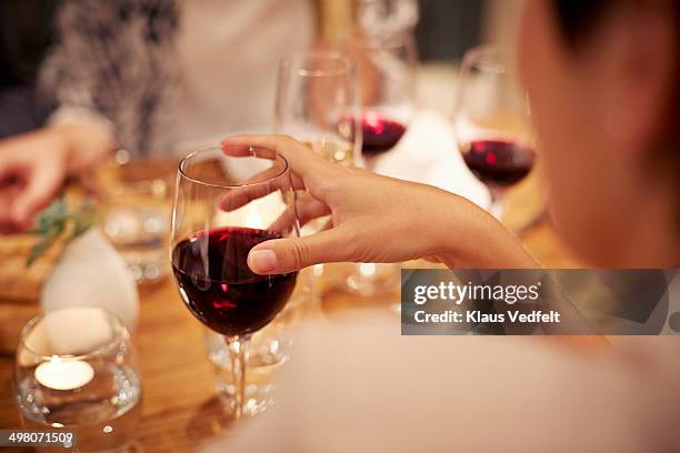 close-up of female holding glass with redwine - vinglas bildbanksfoton och bilder