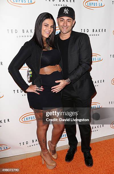 Musical artist Dennis DeSantis and wife attend the 13th Annual Lupus LA Hollywood Bag Ladies Luncheon at The Beverly Hilton Hotel on November 20,...