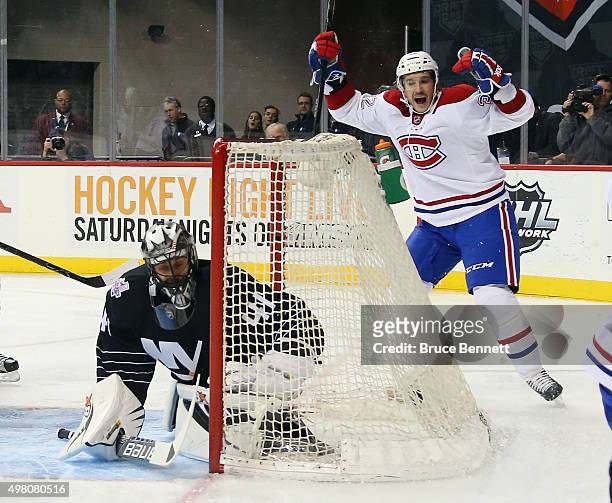 Brian Flynn of the Montreal Canadiens celebrates a first period goal by Jeff Petry against Jaroslav Halak of the New York Islanders at the Barclays...