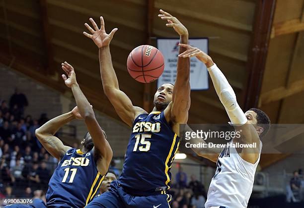 Desonta Bradford and Lester Wilson of the East Tennessee State Buccaneers go up for a rebound against Josh Hart of the Villanova Wildcats at The...