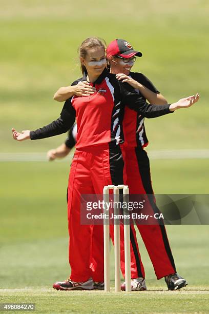 Alex Price and Lauren Ebsary of the Scorpions celebrate a wicket during the WNCL match between South Australia and Queensland at Railsways Oval on...