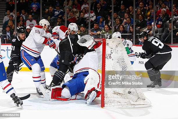 Brock Nelson of the New York Islanders crashes into Carey Price of the Montreal Canadiens during the game at the Barclays Center on November 20, 2015...
