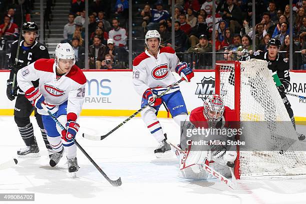 Carey Price makes a save while Nathan Beaulieu and Jeff Petry of the Montreal Canadiens defend the net during the game against the New York Islanders...