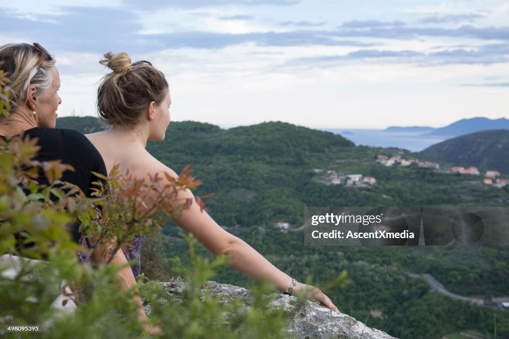 Mother and daughter rest at valley overlook