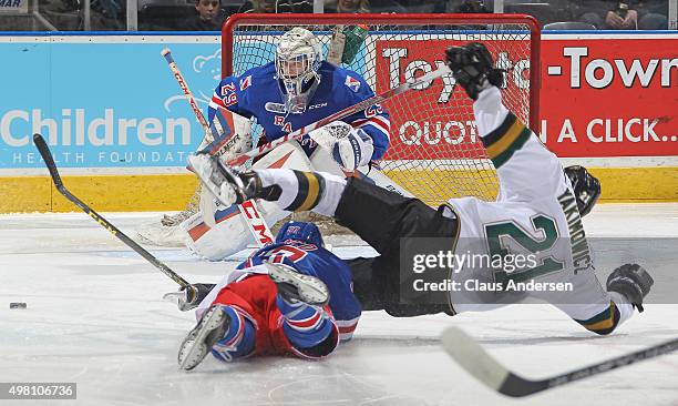 Jeremy Bracco of the Kitchener Rangers takes down Chandler Yakimowicz of the London Knights thus drawing a penalty shot during an OHL game at...