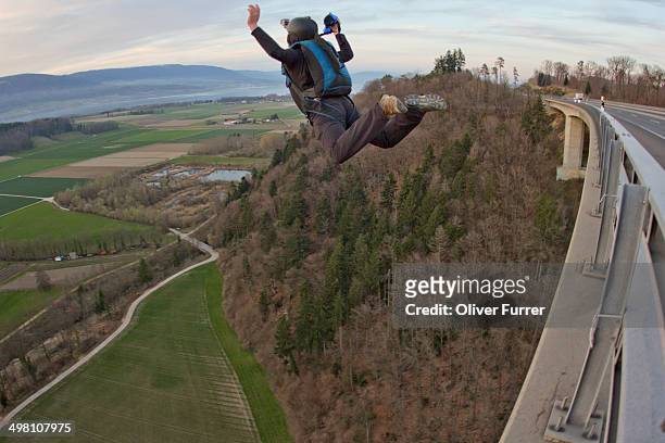 base jumper exit from a bridge down - base jumping stock pictures, royalty-free photos & images