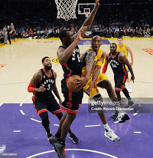 Kobe Bryant of the Los Angeles Lakers throws a wrap around pass against Bismack Biyombo of the Toronto Raptors during the first half of the...