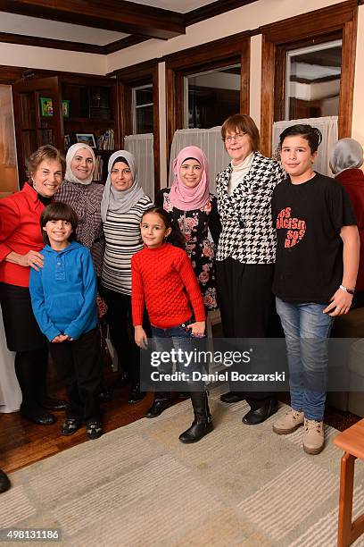 Evanston Mayor Elizabeth Tisdahl, Representative Jan Schakowsky and families pose together as Syrian refugees and community leaders join for a...