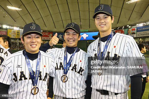 Yuki Matsui, Yasuaki Yamasaki, and Shohei Otani of Japan pose for a group shot after winning the WBSC Premier 12 third place play off match between...