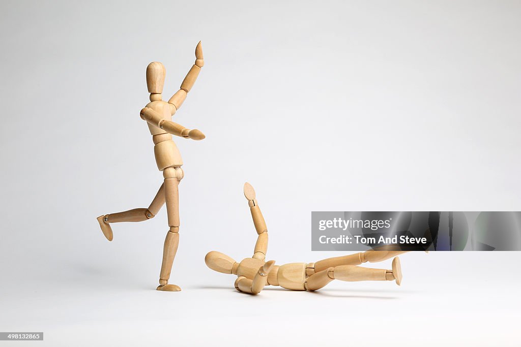 Wooden mannequins fighting