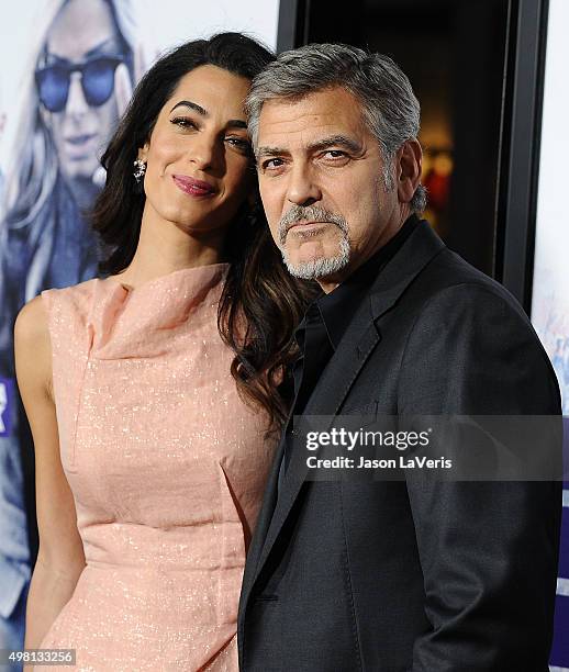 Amal Clooney and George Clooney attend the premiere of "Our Brand Is Crisis" at TCL Chinese Theatre on October 26, 2015 in Hollywood, California.