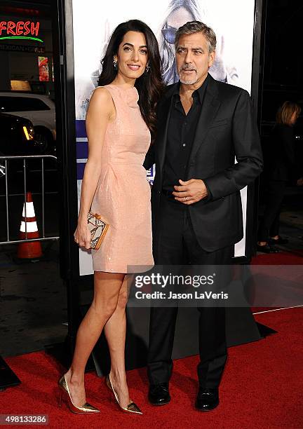 Amal Clooney and George Clooney attend the premiere of "Our Brand Is Crisis" at TCL Chinese Theatre on October 26, 2015 in Hollywood, California.