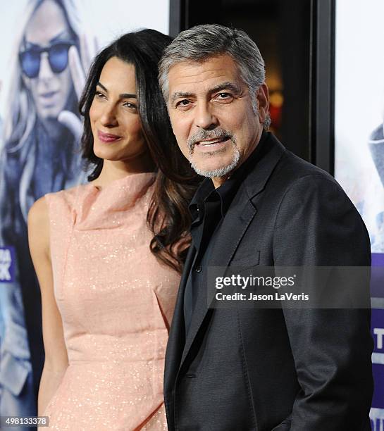 Amal Clooney and George Clooney attend the premiere of "Our Brand Is Crisis" at TCL Chinese Theatre on October 26, 2015 in Hollywood, California.